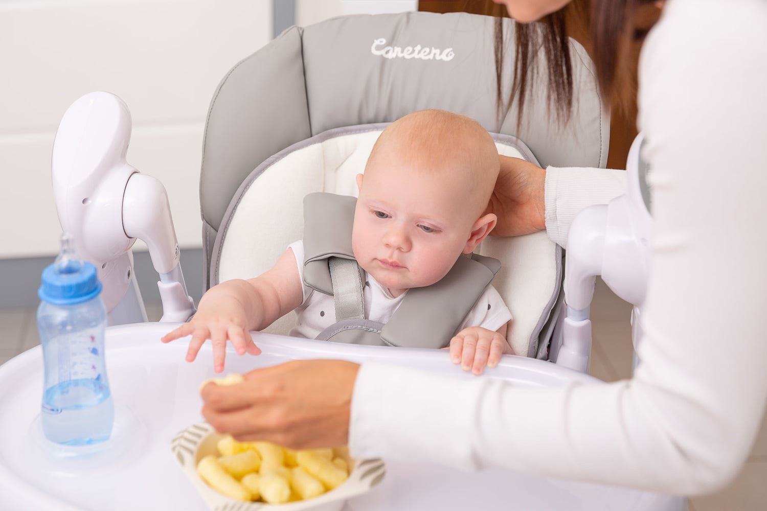 Baby sitting in a high chair at mealtime