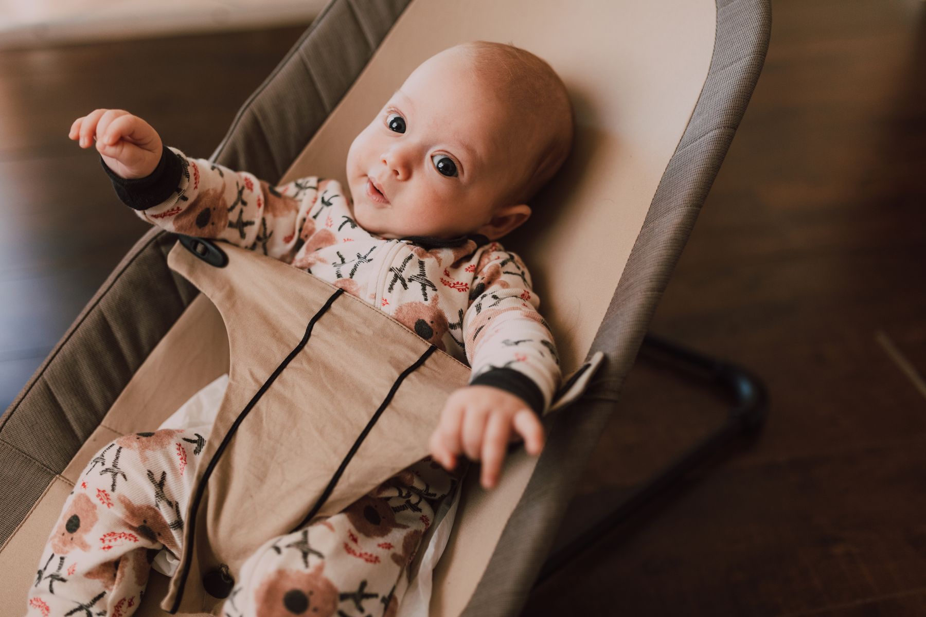 Baby sitting in a soft rocker chair at home